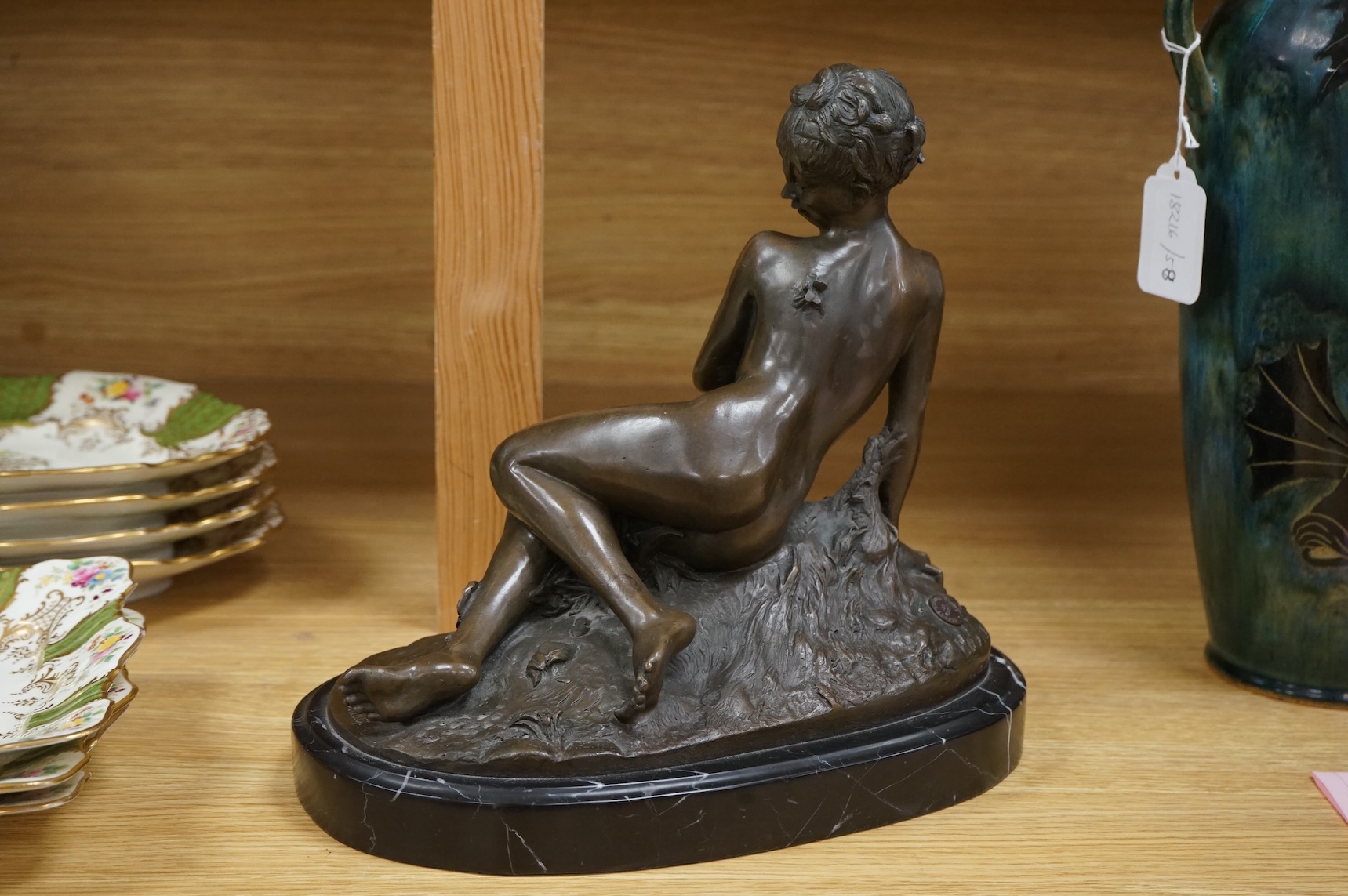 After Mme Leon Bertaux, bronze of a female reclining nude with butterfly, 28cm wide x 27cm high.